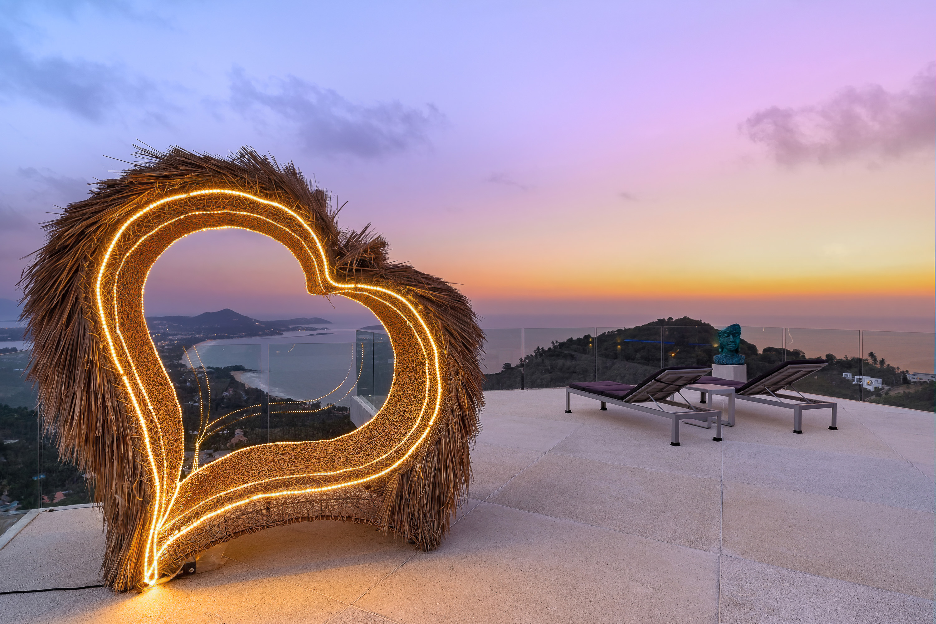 Illuminated heart sculpture at sunset